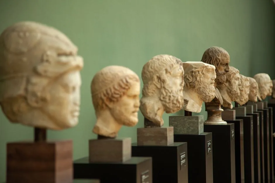 Ancient sculptures displayed in a museum setting, showcasing historical art.