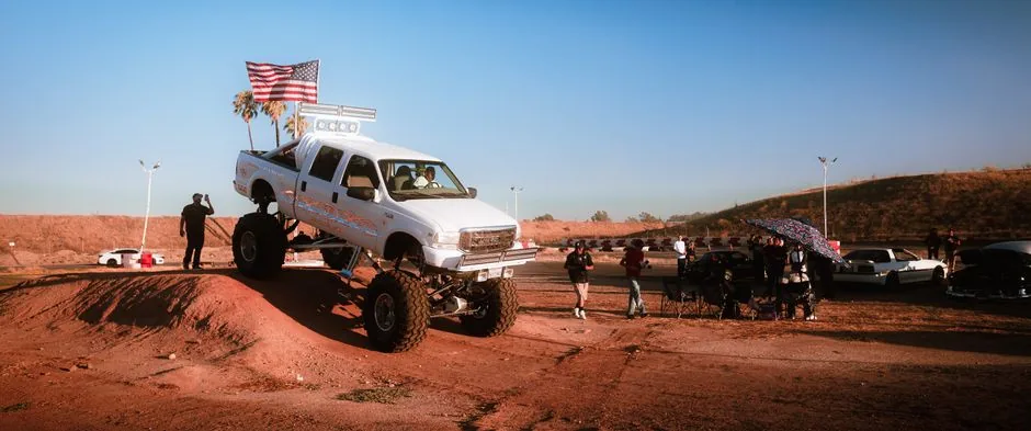 A lifted truck off-road adventure during a sunset event, capturing excitement and community spirit.